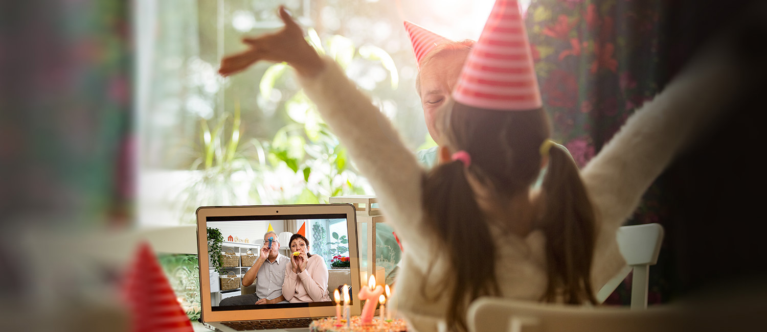  Little girl celebrating her birthday virtually with her grandparents during coronavirus pandemic. 