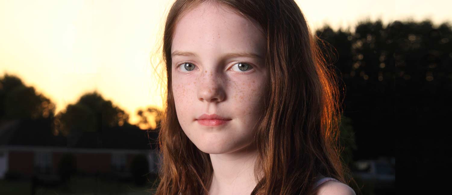  Girl with red hair at sunset. 