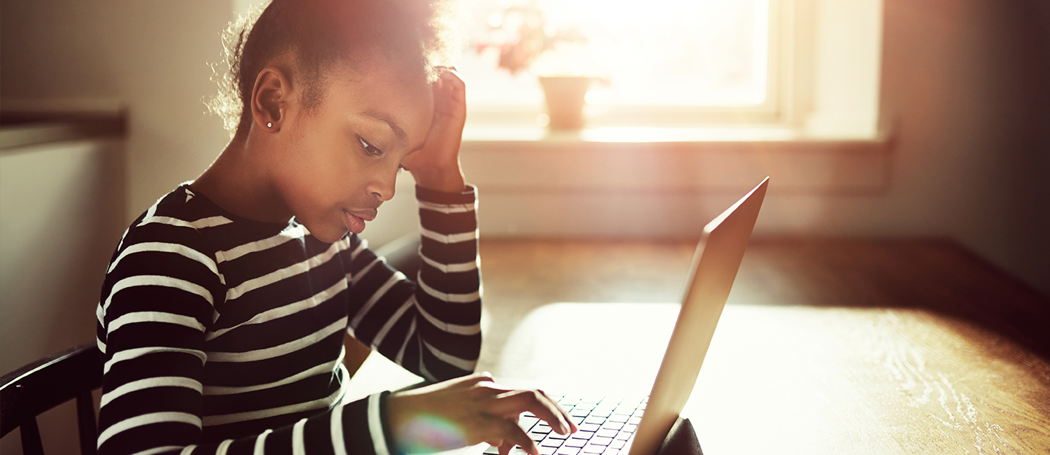  Young girl struggling typing on her laptop computer. 