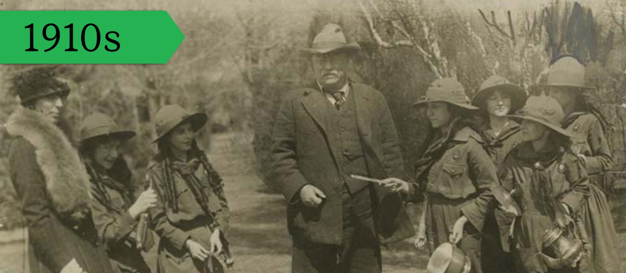 During WWI, American President Theodore Roosevelt presents a family silver plate to Girl Scouts to be melted down for cash for the war effort, 1918.