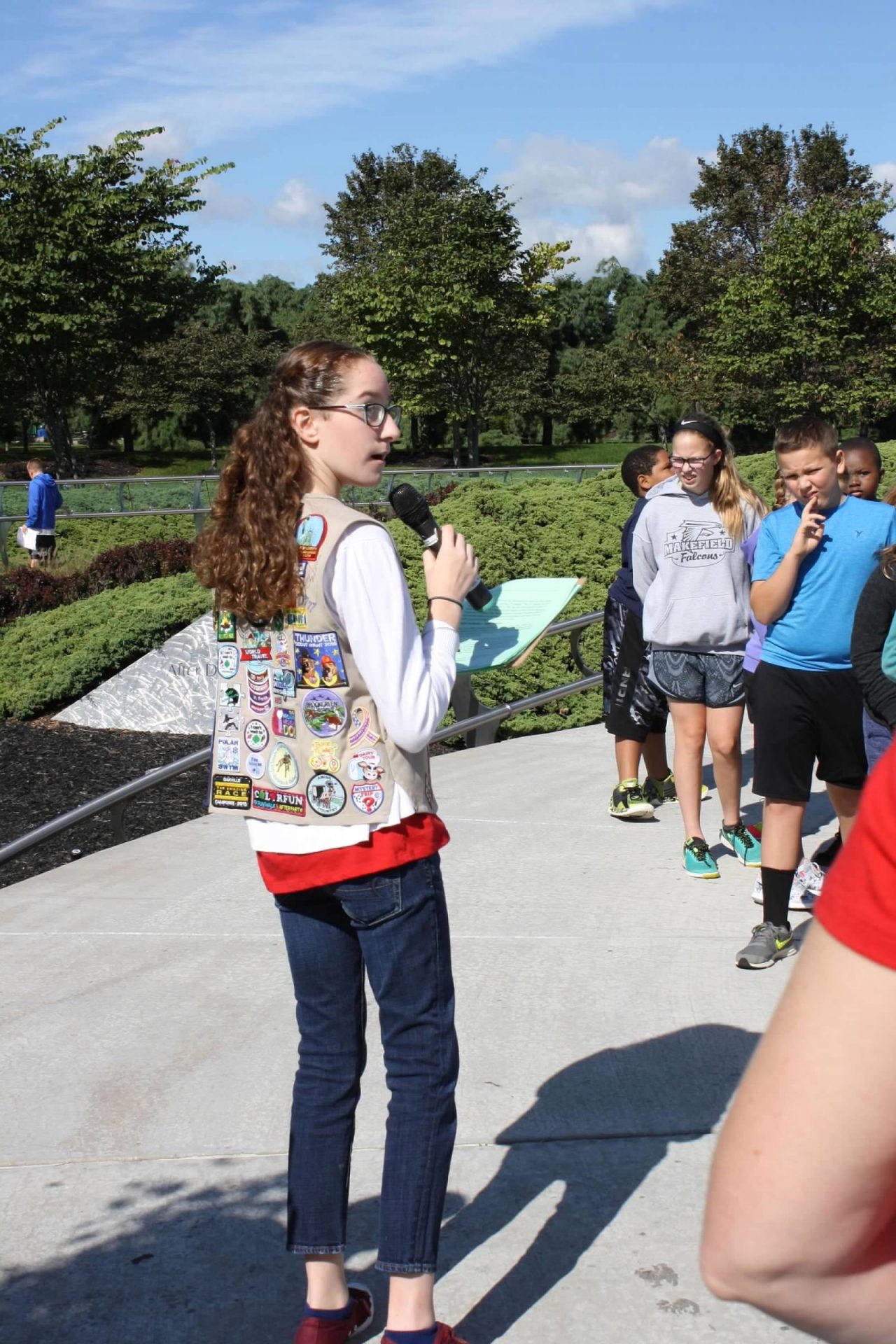Elayna speaking to a crowd of people on a microphone